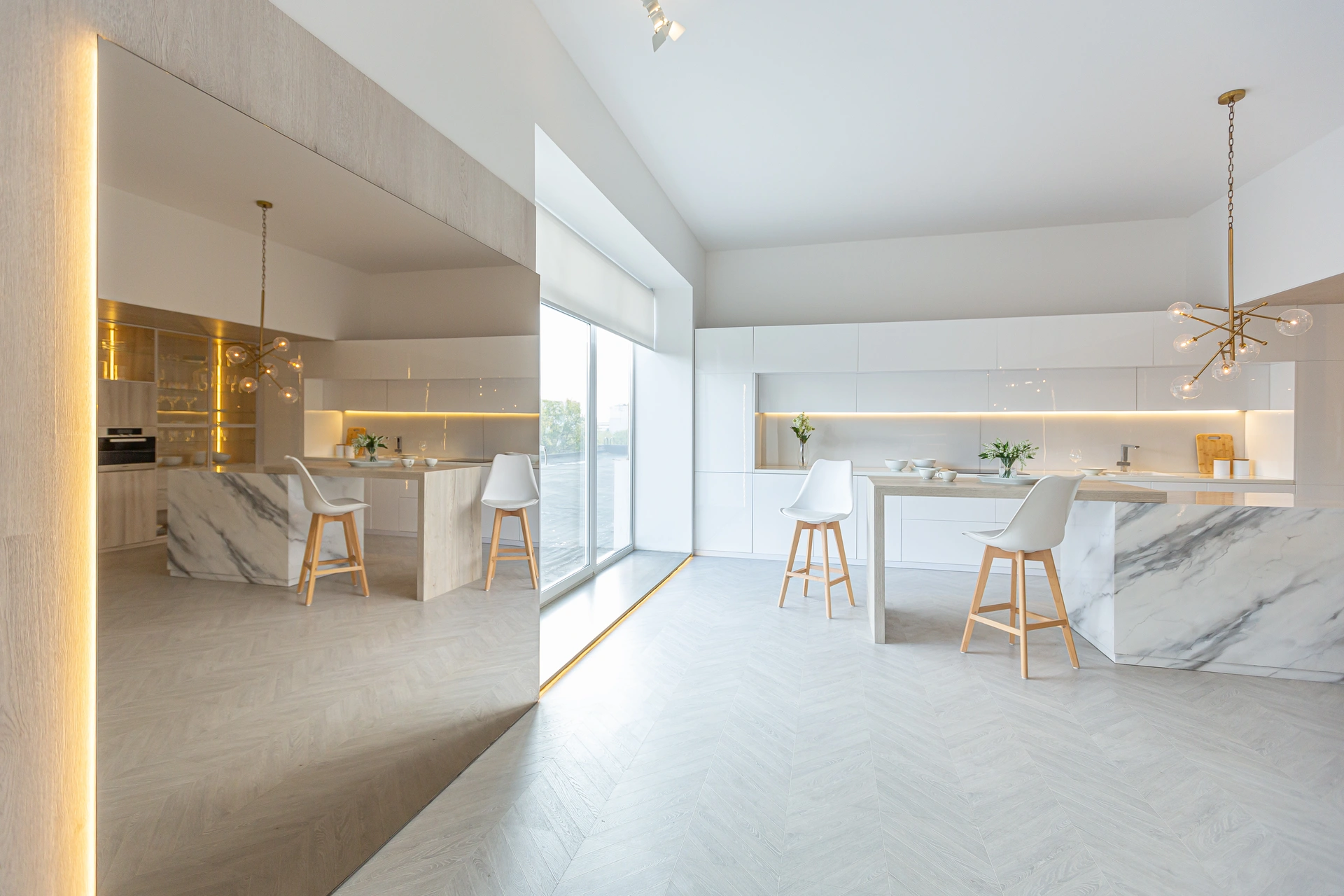 Modern living room with beige sectional, wood coffee table, and wide sliding glass doors opening to a landscaped yard.
